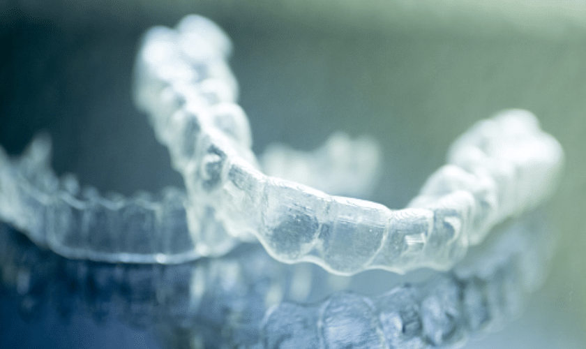 Clear Invisalign aligners displayed showing the transparent dental trays used for teeth straightening treatment.