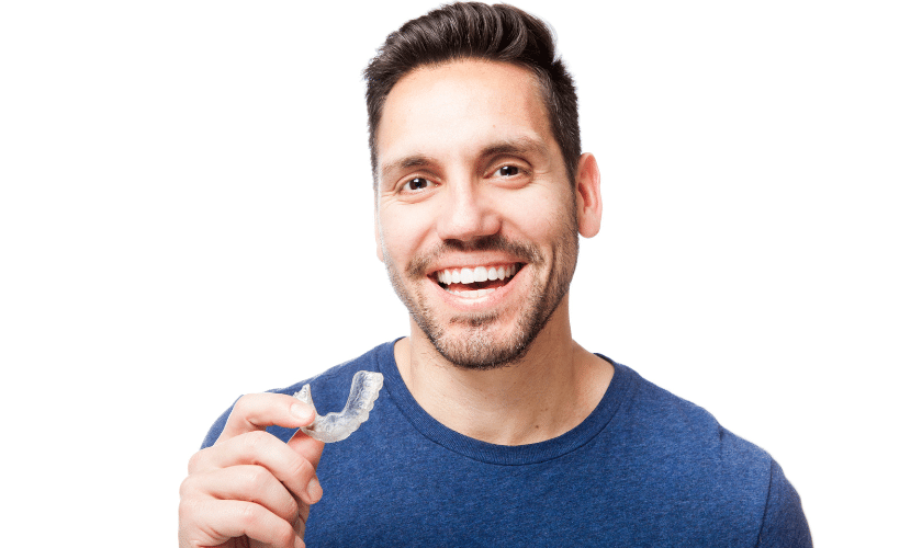 Smiling man holding clear aligner tray for orthodontic treatment.
