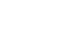 Dr. Cook smiling at camera in professional orthodontic office setting with modern dental equipment visible.