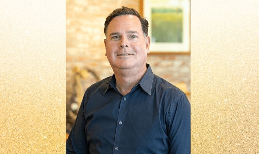 Dr. Marc Dunn, dentist at Woodbury dental practice, smiling in professional portrait.