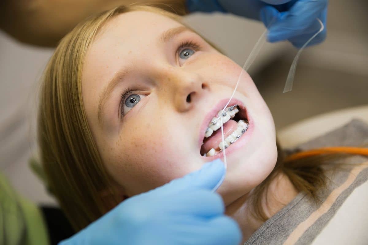 Young patient with dental braces during orthodontic examination at dental office.