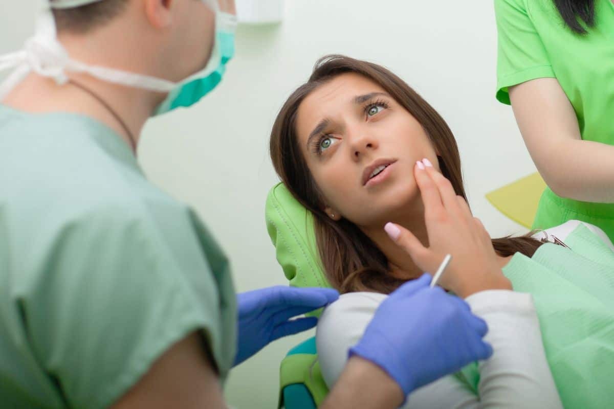 Woman patient receiving orthodontic examination from dental professionals in Woodbury, MN.