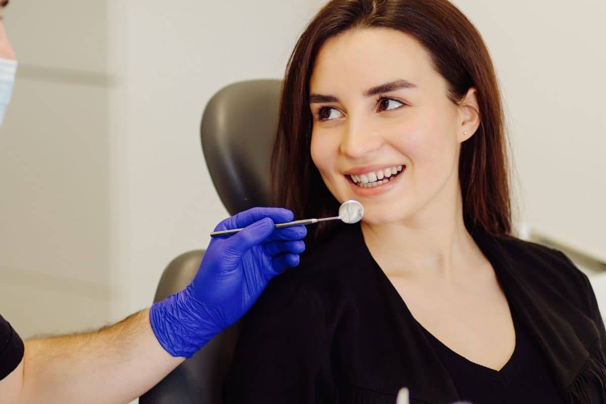 Woman smiling during dental examination at Woodbury, MN practice.